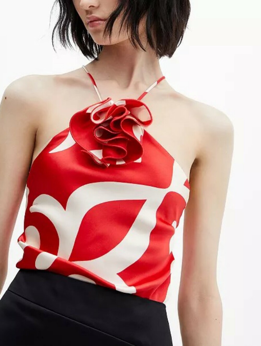 Satin top with decorative flower detail.